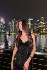 a lady in a velvet sequin long black dress